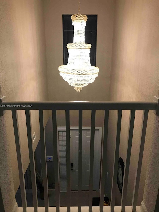 staircase featuring an inviting chandelier