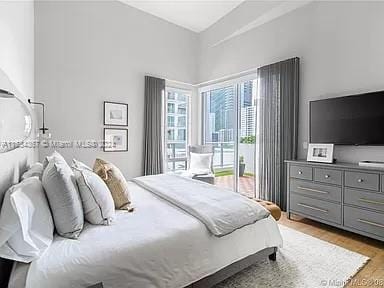 bedroom with light hardwood / wood-style floors and access to exterior