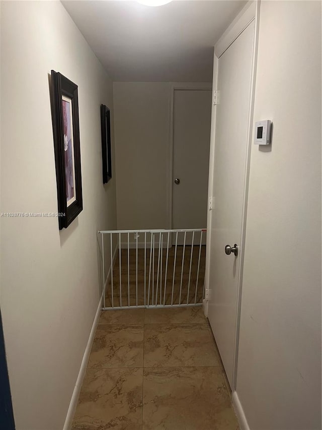 hall with light tile patterned floors