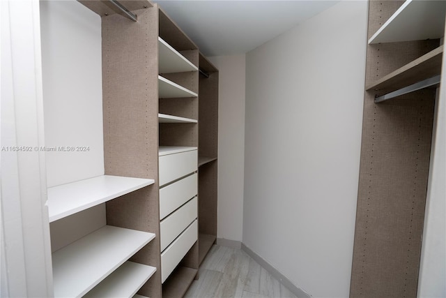 spacious closet featuring light hardwood / wood-style flooring