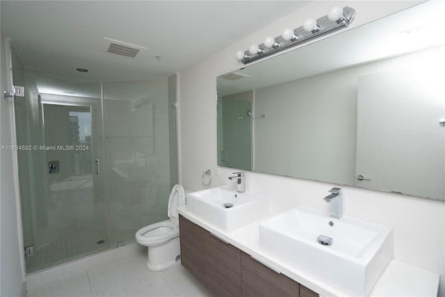 bathroom with tile patterned flooring, an enclosed shower, vanity, and toilet