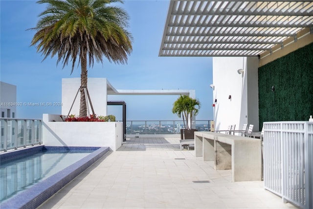 view of patio with a community pool and a pergola