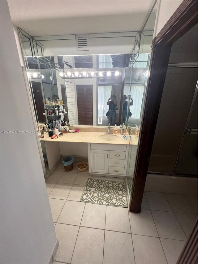 bathroom with vanity, tile patterned floors, and a shower stall