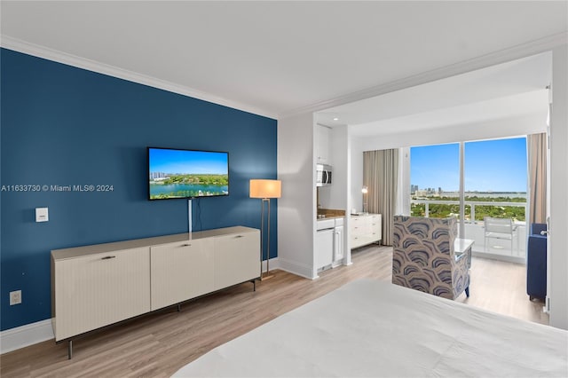 bedroom featuring light hardwood / wood-style flooring and ornamental molding