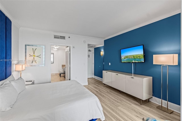 bedroom featuring light hardwood / wood-style flooring and crown molding