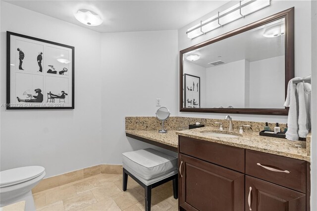 bathroom featuring tile patterned floors, vanity, and toilet