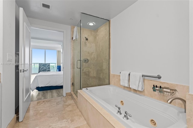 bathroom featuring tile patterned flooring and separate shower and tub