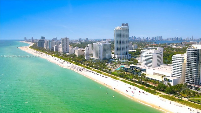 birds eye view of property with a beach view and a water view