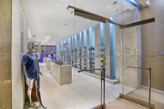 interior space featuring an enclosed shower and tile patterned floors