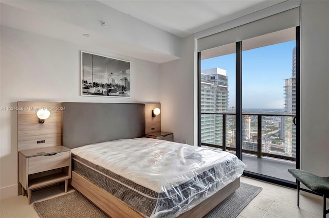 bedroom with tile patterned flooring and expansive windows