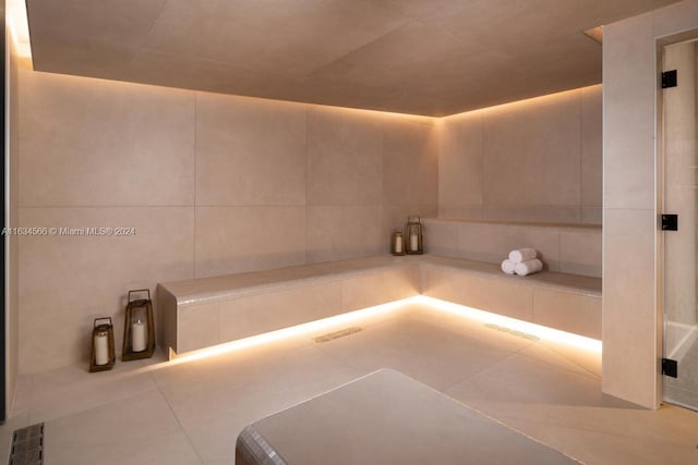 bathroom featuring tile patterned flooring and tile walls