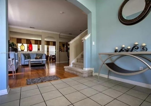 interior space with ornamental molding and tile patterned floors