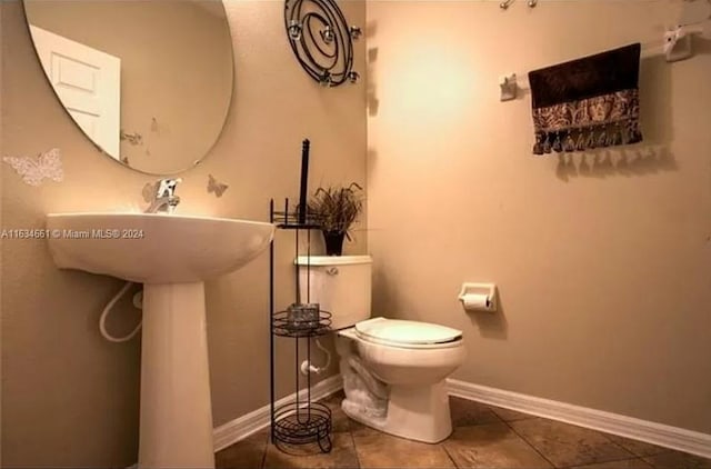 bathroom featuring toilet and tile patterned floors