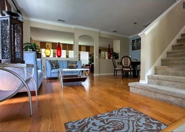 interior space with crown molding and wood-type flooring