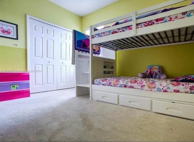 unfurnished bedroom with light colored carpet and a closet