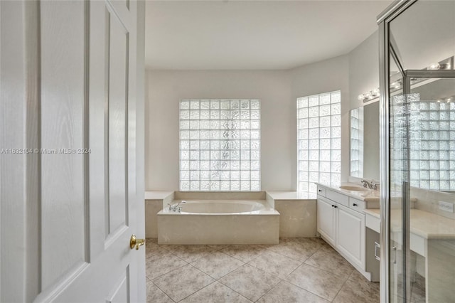 bathroom featuring vanity, tile patterned floors, and shower with separate bathtub