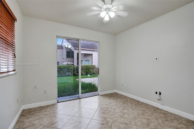 spare room featuring ceiling fan and light tile patterned floors