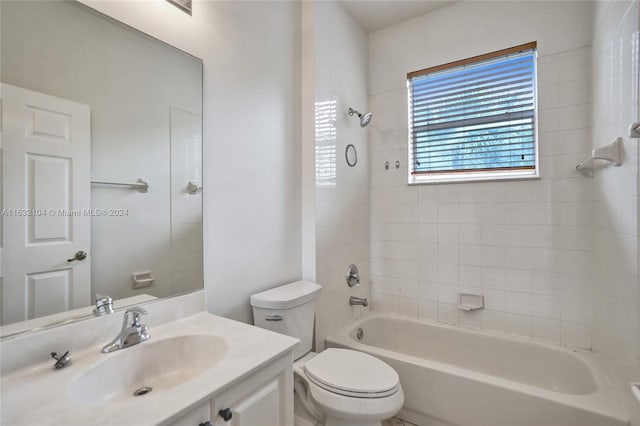 full bathroom with vanity, toilet, and tiled shower / bath combo