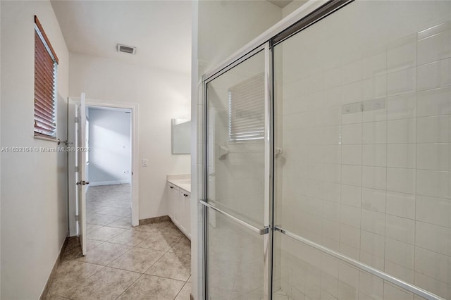 bathroom featuring vanity, an enclosed shower, and tile patterned flooring