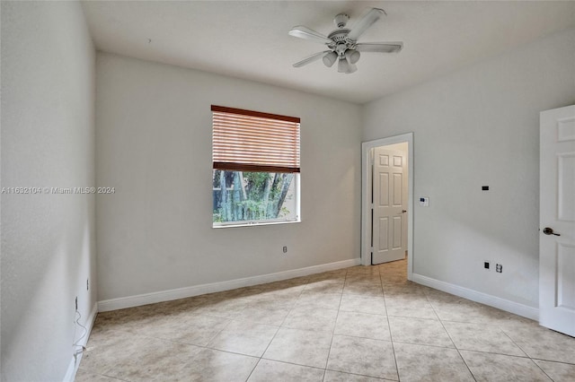 unfurnished room with light tile patterned floors and ceiling fan