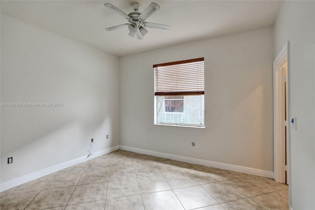 tiled empty room with ceiling fan