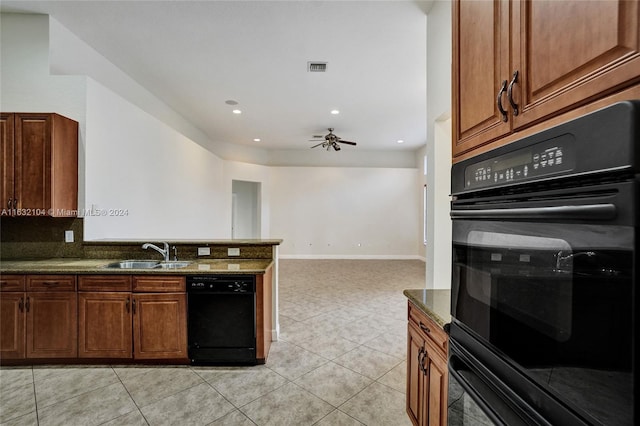 kitchen featuring sink, dark stone counters, light tile patterned floors, ceiling fan, and black appliances