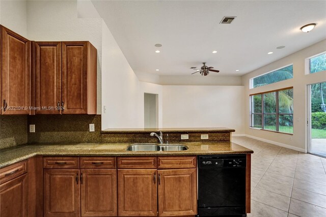 kitchen with sink, light tile patterned floors, dishwasher, stone counters, and decorative backsplash