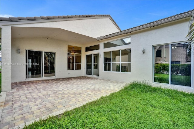 back of property with a patio