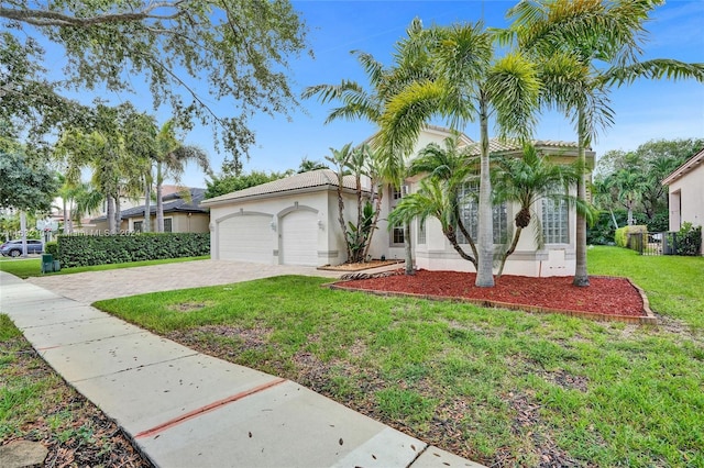 view of front of house with a garage and a front yard