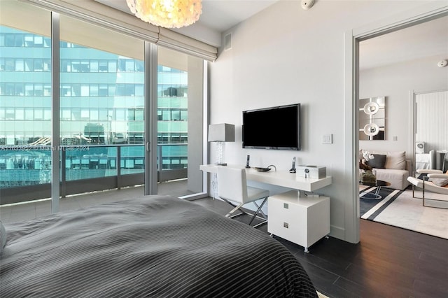 bedroom featuring expansive windows, access to outside, and dark hardwood / wood-style flooring