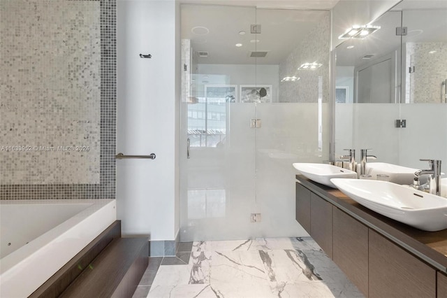 bathroom featuring vanity and shower with separate bathtub