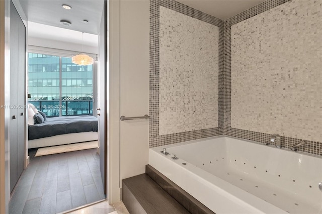 bathroom featuring a tub to relax in and hardwood / wood-style floors