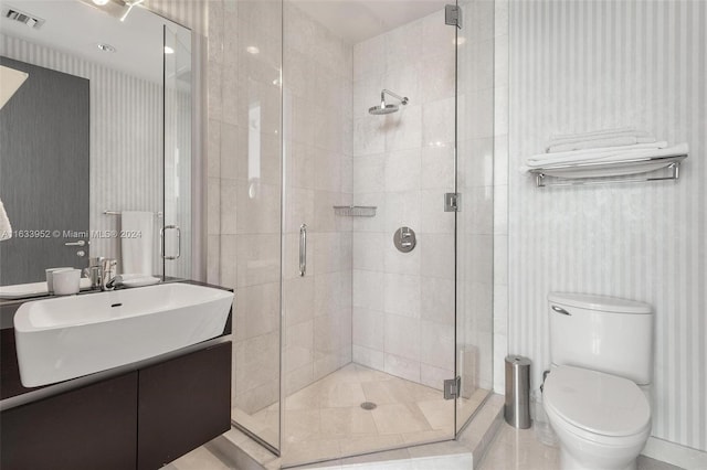 bathroom featuring vanity, an enclosed shower, and toilet