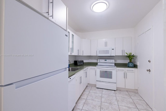 kitchen featuring sink, white cabinets, white appliances, and light tile patterned floors