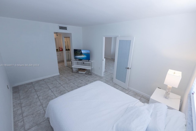 bedroom with light tile patterned floors