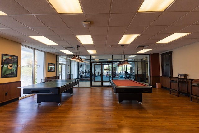 recreation room featuring dark hardwood / wood-style floors, floor to ceiling windows, billiards, and a paneled ceiling