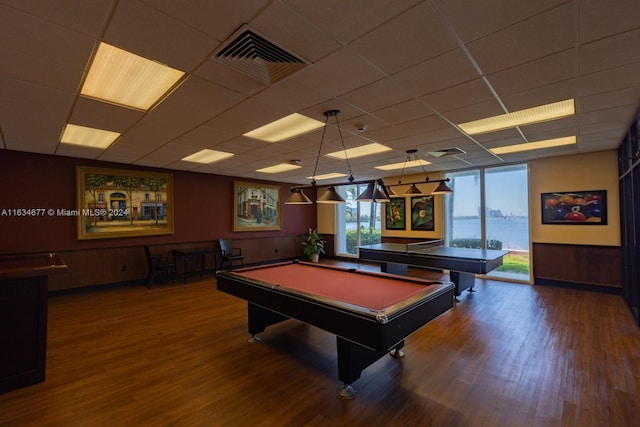 rec room with a water view, a drop ceiling, hardwood / wood-style floors, and pool table