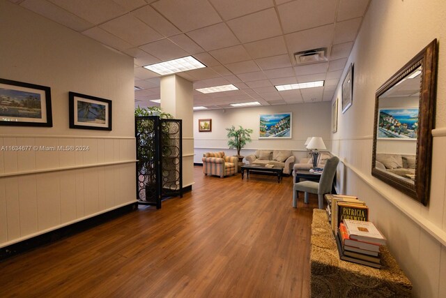 interior space featuring a drop ceiling and hardwood / wood-style floors