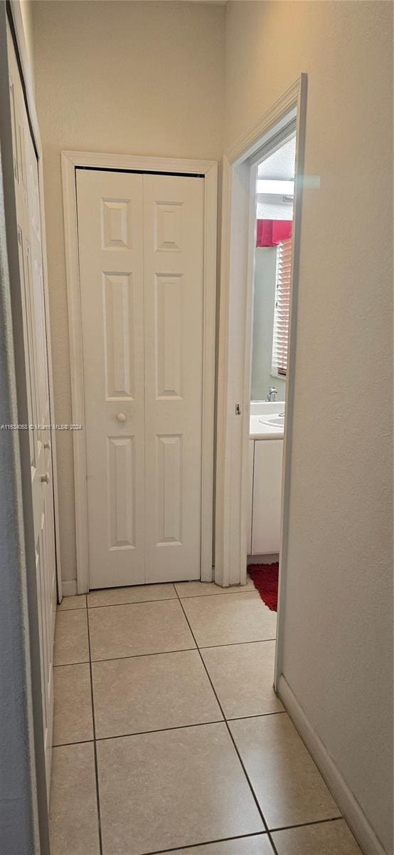 corridor with light tile patterned floors