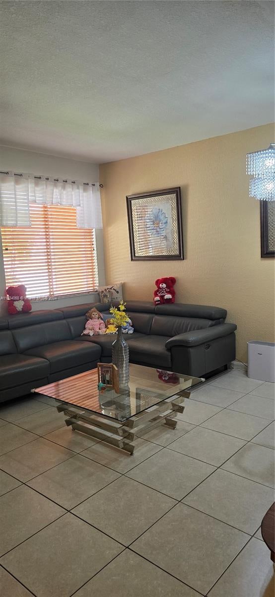 living room with light tile patterned floors and a textured ceiling