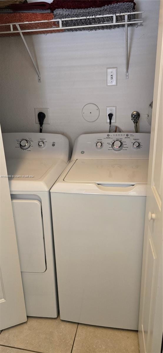 washroom featuring independent washer and dryer and tile patterned floors