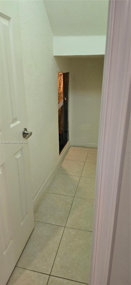 hallway with light tile patterned floors