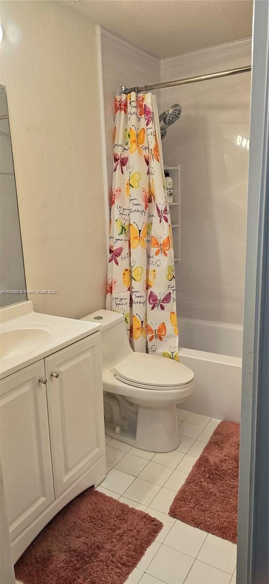 full bathroom featuring tile patterned flooring, vanity, shower / tub combo with curtain, and toilet