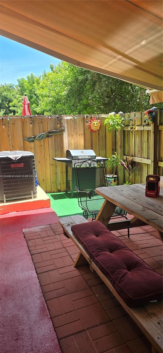 view of patio / terrace with area for grilling and central air condition unit