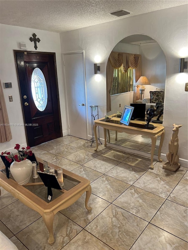 foyer featuring a textured ceiling