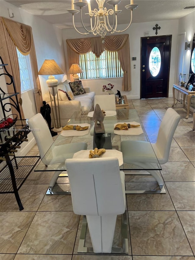 dining area featuring a notable chandelier