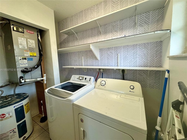 laundry room with water heater, separate washer and dryer, and light tile patterned flooring