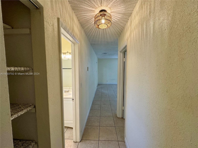 hall with light tile patterned floors