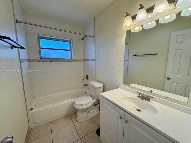 full bathroom with vanity, tiled shower / bath, tile patterned flooring, and toilet