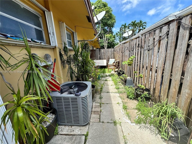 exterior space with cooling unit, an outdoor living space, and a patio